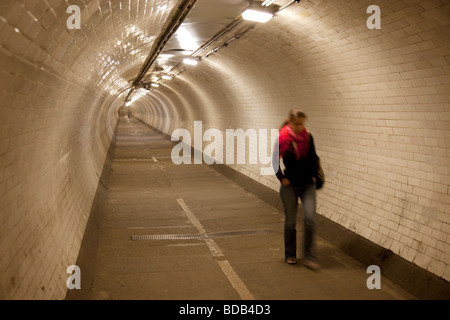 Frau zu Fuß durch den Greenwich Foot Tunnel, der Isle of Dogs mit Greenwich in South East London verbindet. Stockfoto