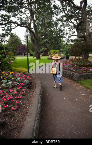 Eine Frau Spaziergänge durch die wunderschönen Blumengärten in Victorias Beacon Hill Park auf Vancouver Island, Kanada. Stockfoto