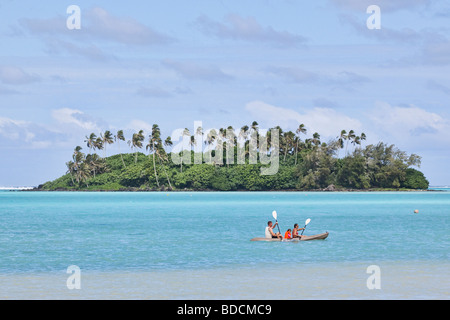 Ein Kajak geht vorbei an einer tropischen Insel am Horizont von Muri Beach auf Rarotonga in Cook-Inseln im Pazifik aus gesehen Stockfoto