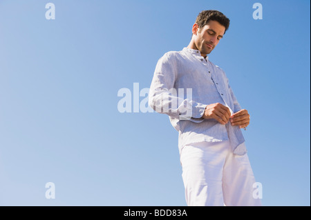Mann, knöpfte Shirt am Strand Stockfoto