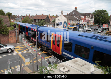 Autos warten, da eine South West Trains s-Bahn ein Bahnübergang in Datchet, Berkshire, UK geht. Stockfoto