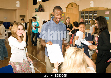 Glücklich schwarzen Teenager männliche Student mit seinem Lehrer seine GCSE A Level Prüfungsergebnis. Stockfoto