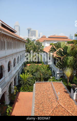 Blick aus dem zweiten Stock Fenster Raffles Courtyard auf die Skyline der Stadt hinter Raffles Hotel, Singapur Stockfoto