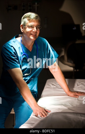 Porträt von Reifen Arzt in Scrubs sitzen im Krankenzimmer Stockfoto