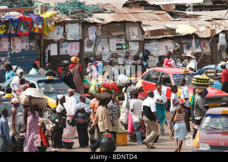 Menschen, die die waren auf ihren Köpfen in der sehr belebten Kumasi Markt in zentralen Kumasi. Ghana. West-Afrika. Stockfoto