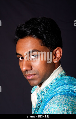 Schönes Gesicht eines indisch-hinduistischen jungen Mannes mit Zipfelbildung tragen blaue Dhoti. Porträt von hübschen Desi männlich, isoliert. Stockfoto