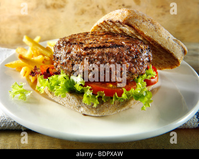 Gepfefferter Beef-Burger mit Pommes Frites und Vollkorn Brötchen Stockfoto