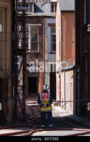 Ein Feuerwehrmann starrt eine verbrannte Gebäude nach der 30. April 2007 Dale Street-Feuer in Manchester, England. Stockfoto