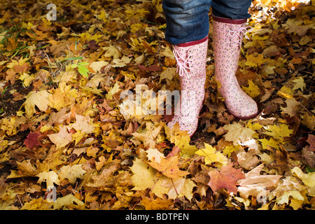 Eine Frau trägt Schlauchboote im herbstlichen Wald Stockfoto