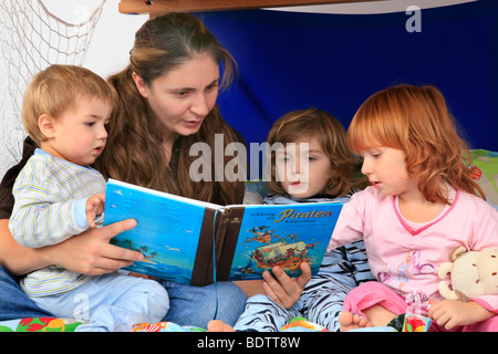 Mutter ein Buch über Piraten zu ihren Kindern in ein Billi-Bolli Hochbett Stockfoto