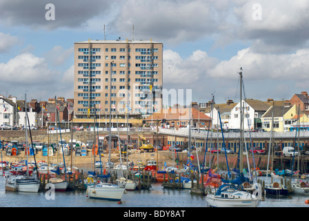 Bridlington Hafen, East Yorkshire, England, UK mit einem Hochhaus im Hintergrund Stockfoto