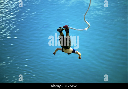 Mann fiel kopfüber von Bungee-Seil in blauem Wasser, Neuseeland Stockfoto