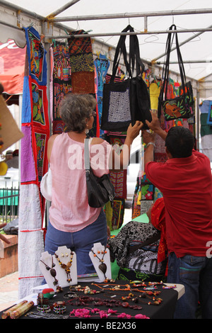 Eine Frau einkaufen Hand machte Taschen auf dem Display auf einem Straßenmarkt in Panama-Stadt. Stockfoto