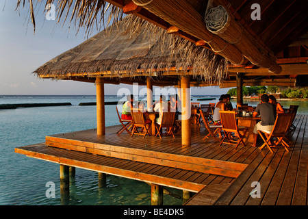 Menschen beim Frühstück im offenen Restaurant, Dach mit Palmwedeln, Restaurant, Lagune, Meer, Malediven Insel Rihiveli, Süd Male am Stockfoto