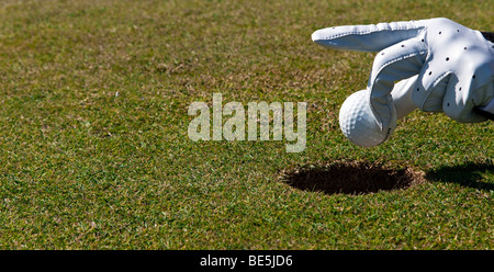 Umsetzung ohne Golfschläger, Hand, die einen Golfball Stockfoto