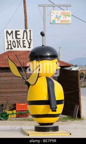 Biene wie Mann Anzeigenverkaufs-Honig aus einer Hütte am Straßenrand in Nikiti Chalkidiki Griechenland EU Stockfoto