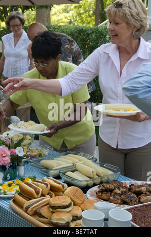 Nachbarschaft Picknick buffet Tisch mit Hot Dogs, Hamburger, Bbq Chicken Maiskolben. Stockfoto