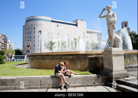 Touristen sitzen vor Kaufhaus El Corte Ingles. Plaça Catalunya. Barcelona. Spanien Stockfoto