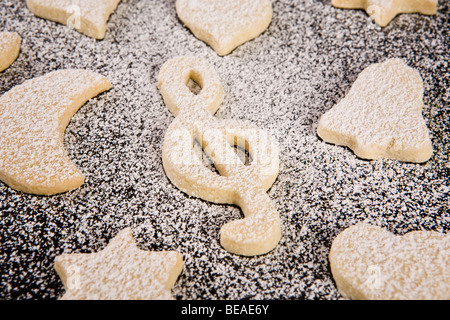 Verschiedene geformte Plätzchen mit Puderzucker darauf Stockfoto