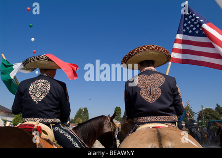 Zwei mexikanische amerikanischen Cowboys, amerikanische und mexikanische Flaggen halten. Stockfoto