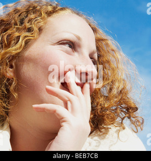 Nahaufnahme einer jungen Frau lächelnd und wegsehen Stockfoto