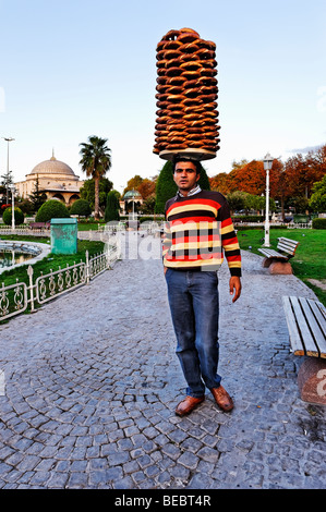 Am frühen Morgen im Istanbuler Stadtteil Sultanahmet. Eine junge türkische Mann trägt eine Lieferung von Brot - frisch gebackene Simit rollen. Stockfoto