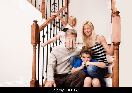 Familie sitzt auf einer Treppe Stockfoto