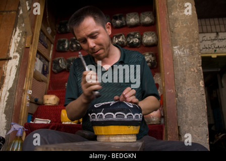 Traditionellen uigurischen Hut handwerklichen Arbeiten in einem Straßenmarkt von Kashgar, Provinz Xinjiang, China 2008. Stockfoto