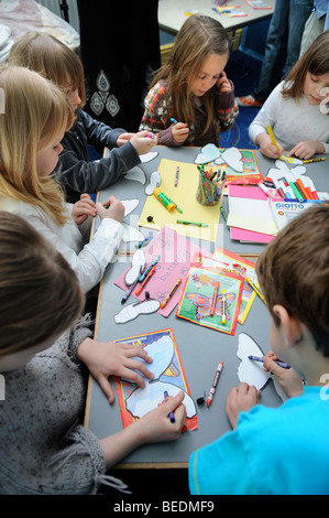KINDER, DIE ZEICHNUNG AUF AUSSCHNEIDEN SCHMETTERLINGE AN EINEM SONNTAG SCHOOL UK Stockfoto