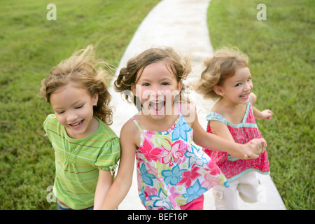 Drei Schwester Mädchen spielen laufen auf den grünen Park im freien Stockfoto