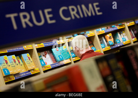 WH Smiths wahre Verbrechen und Horror Literatur auf Verkauf im Abflugbereich Einkaufsmeile der Flughafen Heathrow Terminal 5. Stockfoto