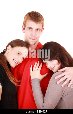 Porträt des jungen Mann umarmt zwei junge Frauen, Studio gedreht Stockfoto