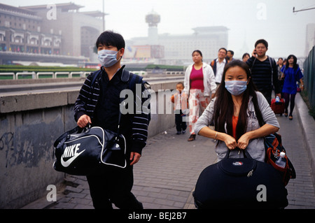 Ein Mann und eine Frau tragen Masken zum Schutz gegen schwere Luftverschmutzung in Peking, China. 30 Sep 2009 Stockfoto