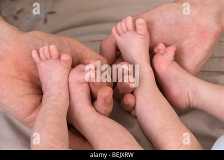 Eltern demonstrieren Containment hält für Frühgeborene, eineiigen Zwillingen, 11 Wochen alt, geboren 10 Wochen zu früh Stockfoto