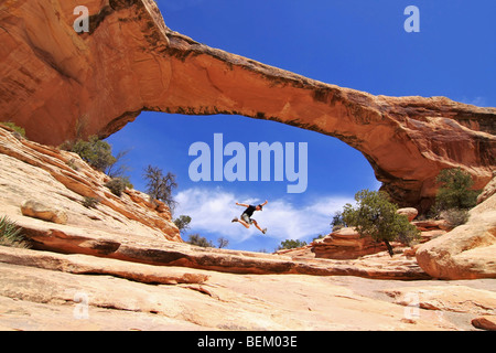 Mann springt innerhalb der Owachomo Brücke in Natural Bridges National Monument, Utah Stockfoto