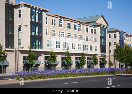 Von einer Straße gesehen einem gemischt genutzten Gebäude mit Wohnungen und Büroflächen. Parken Sie Broadway am El Camino Real in Millbrae, CA Stockfoto