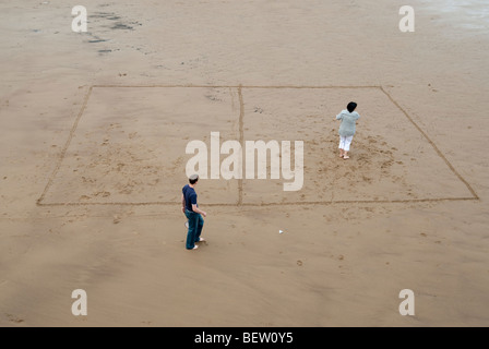 Paar spielen Badminton in einer Hand markiert Gericht an einem Strand in Yorkshire Stockfoto