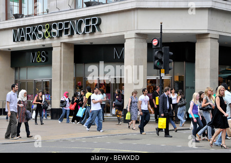 Geschäftiges Shopping in der Oxford Street, viele Einkaufslustige und Touristen, die vor der Marks und Spencer Marble Arch Geschäfte und Geschäfte vor London, Großbritannien, laufen Stockfoto