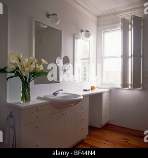 Weißer Unterschrank mit montierten Waschbecken und Toilette im schwarz