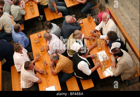 Trinker an einem Tisch auf das Oktoberfest in München in Süddeutschland Stockfoto