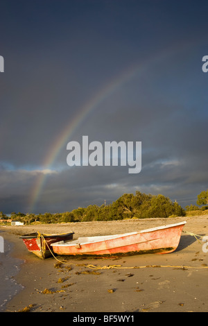 Kalbarri, Australien. Zwei Boote am Ufer des Murchison Rivewith ein Regenbogen in der Ferne. Western Australia Stockfoto