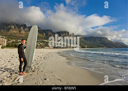 Surfer auf Camps bay Strand mit zwölf Apostel auf den Tafelberg im Hintergrund. Kapstadt-Südafrika Stockfoto