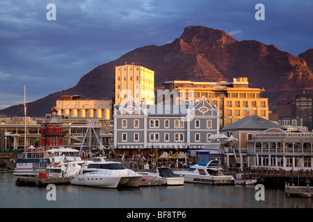 Sonnenuntergang über der V & A Waterfront, Cape Town, Südafrika. Menschen besuchen das Wasser für seine Geschäfte, Cafés, Bars und restaurants Stockfoto