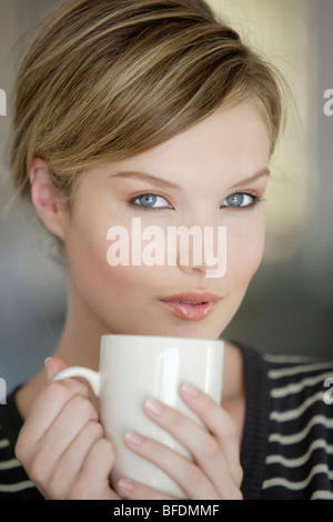 Junge Frau hält eine Kaffeetasse, Nahaufnahme Stockfoto
