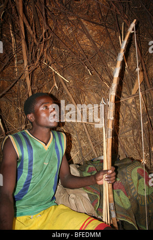 Hadza Stamm Mann mit Jagd Bogen in seine Wohnung, Taken in der Nähe von Yaeda Chini, Tansania Stockfoto