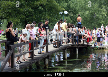 Menschen drängen sich auf Holzsteg Brücke. Pliva Seen, Bezirk Jajce, Bosnien und Herzegowina. Stockfoto