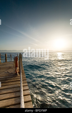 Sonnenaufgang über Taba Heights, Taba, Rea Meer, Ägypten, Afrika, mit ruhigen blauen Gewässern Satz gegen ein Tauchen Steg. Stockfoto