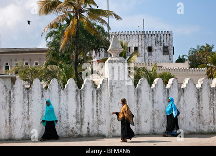 Tansania, Sansibar, Stonetown. Sansibar Damen Wandern entlang Mzingani Straße vorbei an dem Palastmuseum in Zanzibar s Stone Town. Stockfoto