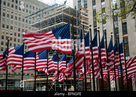 Hinter eine Anzeige von einem amerikanischen Flaggen rund um Rockefeller Plaza in NY Arbeitnehmer schmücken Sie weltweit berühmteste Weihnachtsbaum Stockfoto