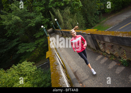 Frau läuft auf Brücke im Arboretum, Seattle, Washington, USA Stockfoto